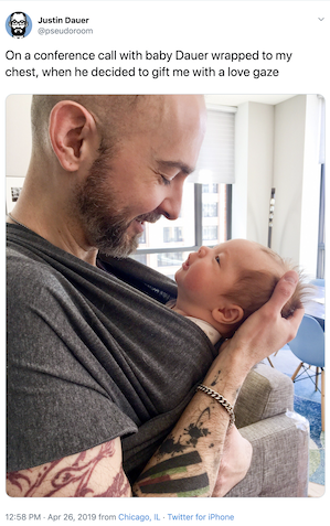 A man cradles his newborn.