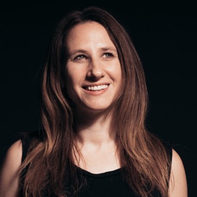 Photo of Alexis Lloyd. Head shot, dark background.